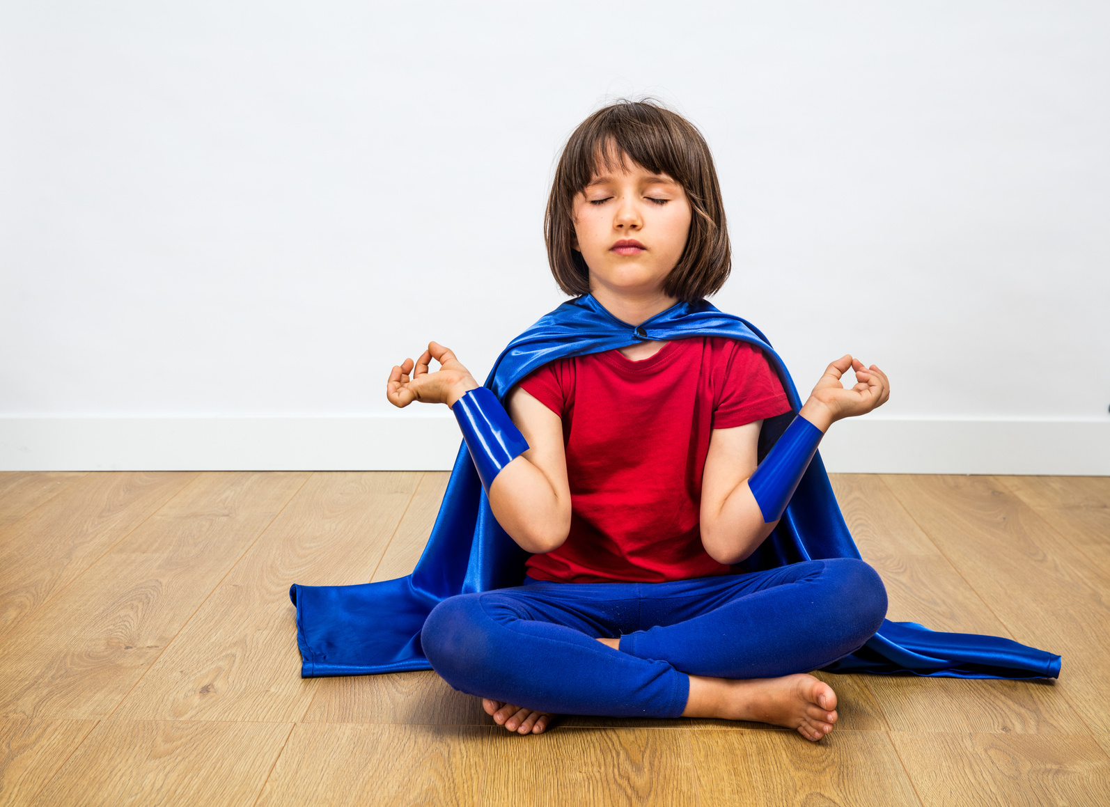 relaxed superhero child relaxing with yoga, mindfulness, meditation, bare feet